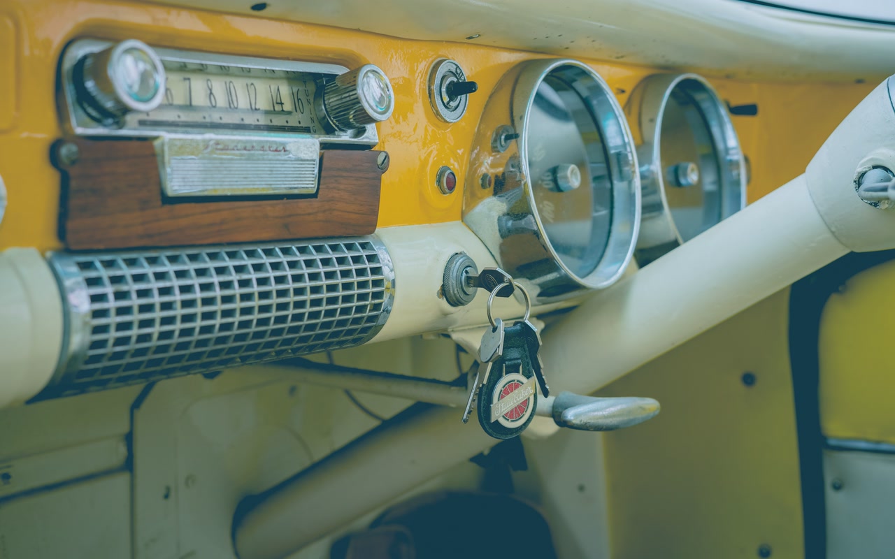 Close-up of a vehicle dashboard, speedometer and ignition keys