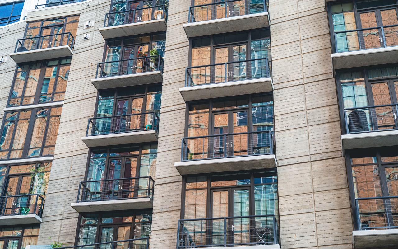 Modern apartment building with concrete walls and glass balconies