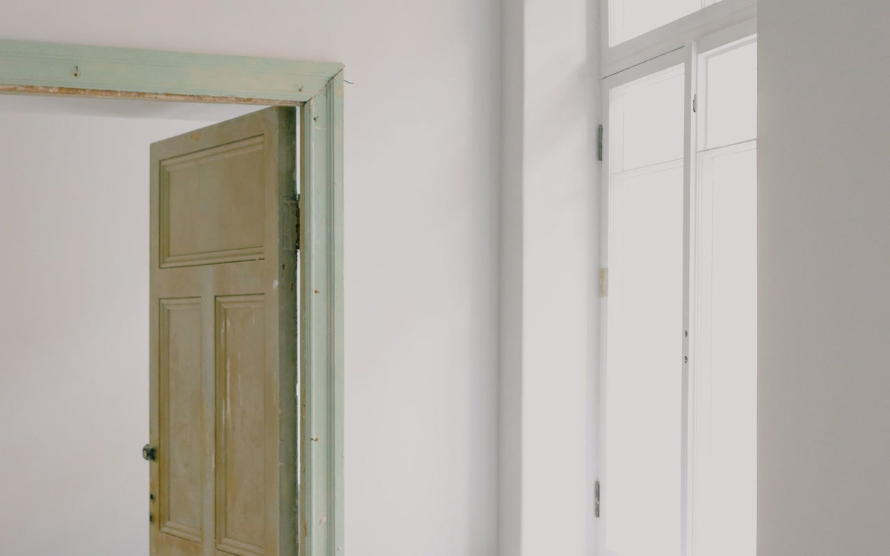 Bright apartment interior with windows and construction materials during renovation